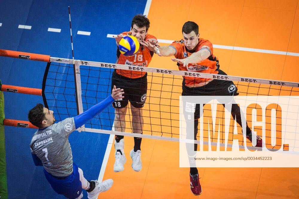 Berlin Germany 29 04 2018 Athanasios Protopsaltis Friedrichshafen 7 against the block from Pierre Pujol BR Volleys 18 and Graham Vigrass BR Volleys 8 at Playoff Final Game 2 of the Volleyball Bundesliga between Berlin Recycling Volleys and VfB Friedrichshafen