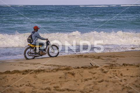 PLAYA LIMON, DOMINICAN REPUBLIC 28 DECEMBER 2019: Biker on the Caribbean beach biker, motorbike, playa limon, sea, beach, dominican, republic, dominican republic, unsafe, bike, sport, man, sky, water, travel, happy, silhouette, sun, nature, fun, outside, ride, coast, motorcycle, outdoors, happiness, leisure, outdoor, active, adventure, biking, person, activity, evening, ocean, life, adult, pleasure, transport, sunlight, rider, action