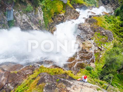 Man climbing on a via ferrata near Stuibenfall, Austria ferrata, alps, waterfall, mountain, water, climbing, rock, tourism, via, steep, climber, ladder, climb, sport, outdoor, travel, via ferrata, hiking, adrenaline, landscape, nature, leisure, iron, otztal, austria, man, road, peak, adventure, summit, valley, courage, trekking, alpine, vertical, extreme sports, cascade, cliff, europe, gorge, stream, european alps, ferata, feratta, ferratta, helmet, rope, red, dangerous