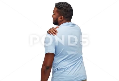 Health problem and people concept - unhealthy african american man suffering from shoulder pain over white background man, shoulder, pain, ache, tension, health, problem, unhealthy, healthcare, suffering, painful, hurt, hand, person, adult, sick, tired, people, concept, touching, bad, unwell, young, guy, t-shirt, one, shirt, white, background, copyspace, casual, blank, african, african american, black, isolated, studio shot, back, rear view