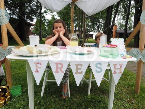 A closeup of children selling fresh lemonade and cupcakes, lemon aid stand for children business in Ontario, Canada children, smart, business, lemonade, cupcakes, sweet, drink, child, food, dessert, confectionery, refreshing, refreshment, beverage, fresh, trade, trading, post, selling, sale, juice, closeup, horizontal, lemon, aid, stand, ontario, canada