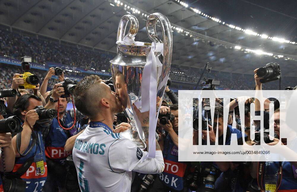 Football UEFA Champions League Final 2018 Real Madrid FC Liverpool at the Kiev Olympic Stadium Ukraine Winners Real Madrid celebrates winning the Champions League Sergio Ramos Real Madrid with the Cup surrounded by journalists