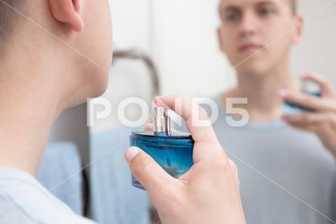 Young handsome man applying parfume in bathroom applying, aroma, background, bath, bathroom, beauty, body, bottle, care, casual, clean, cologne, cosmetic, face, fashion, fragrance, freshness, guy, handsome, head, health, healthcare, healthy, home, hygiene, indoor, lifestyle, liquid, looking, male, man, masculinity, men, mirror, morning, people, perfume, person, portrait, reflection, routine, shaved, skin, skincare, spray, stand, wash, wellbeing, white, young