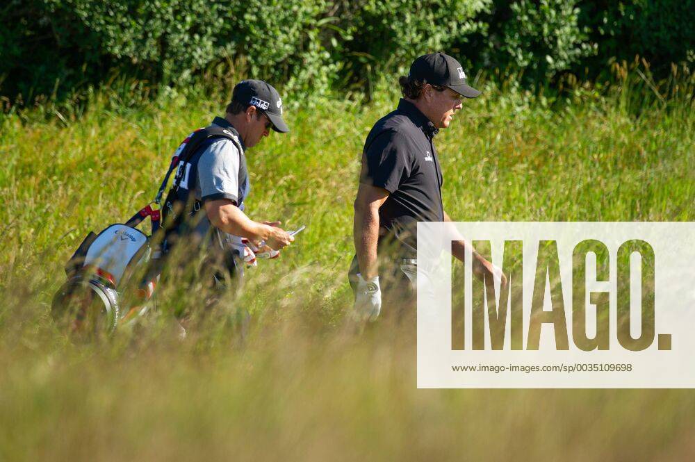 Phil Mickelson from the United States and caddy Tim Mickelson walk on the 10th fairway in the first round of the 118th U.S. Open Championship at Shinnecock Hills Golf Club in Southampton, New York on June 14, 2018. NYP20180614110 COREYxSIPKIN