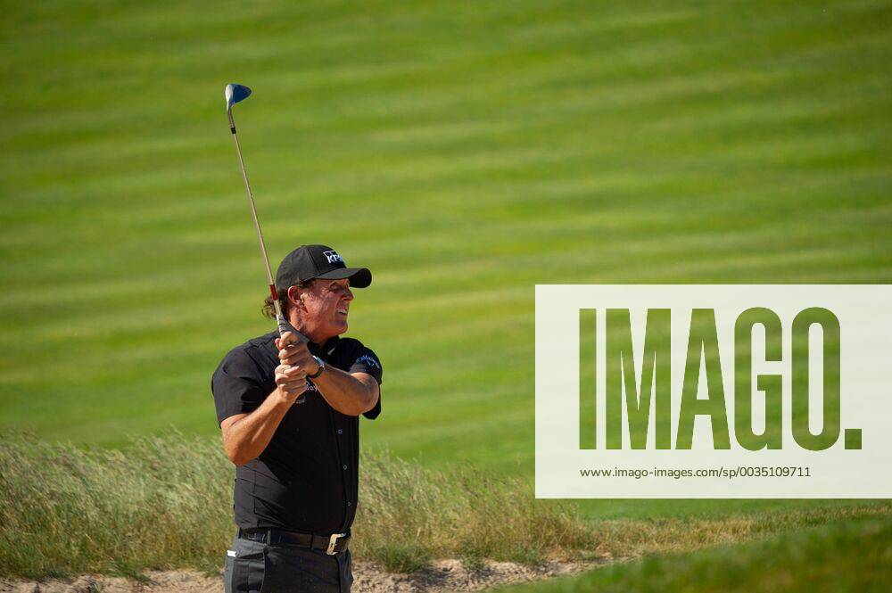 Phil Mickelson hits out of a bunker near the 11th green in the first round of the 118th U.S. Open Championship at Shinnecock Hills Golf Club in Southampton, New York on June 14, 2018. NYP20180614123 COREYxSIPKIN