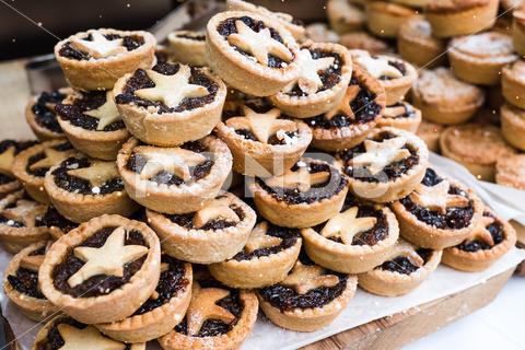 A closeup of Piles of delicious Christmas mince pies at Bath Christmas market mince, pies, food, snack, fresh, breakfast, delicious, organic, healthy, nutrition, rustic, christmas, winter, holiday, baking, celebration, dessert, season, festive, xmas, sweet, year, traditional