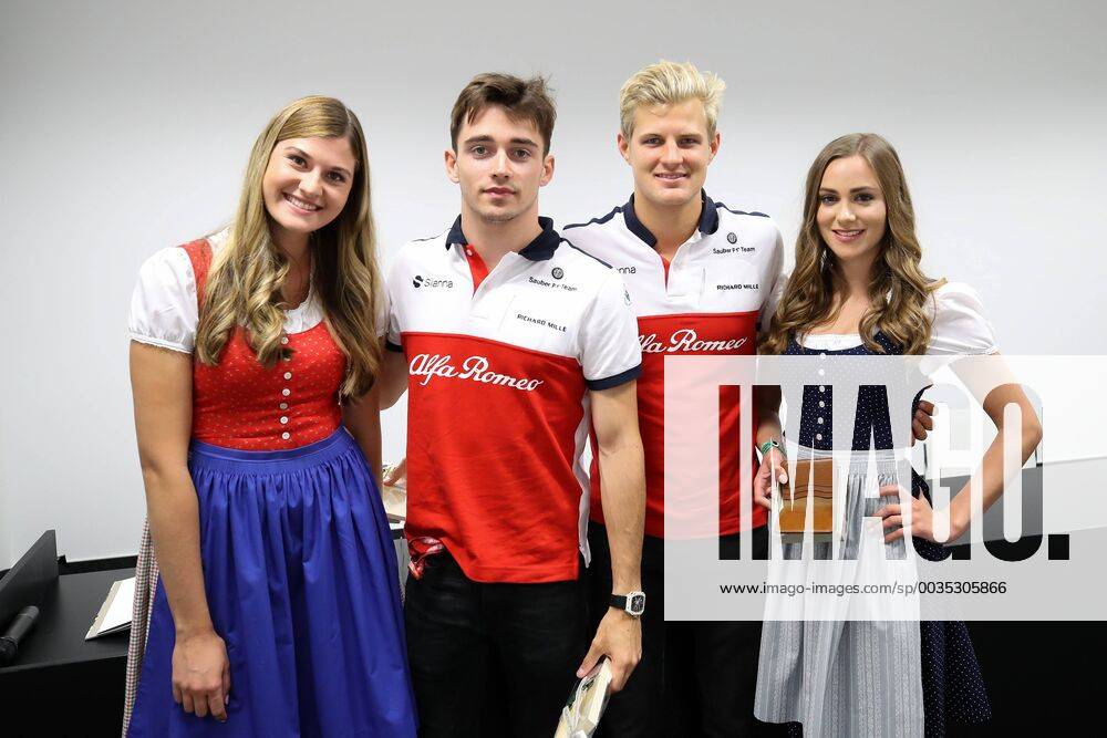 FORMULA 1 - GP of Austria 2018 SPIELBERG,AUSTRIA,29.JUN.18 - MOTORSPORTS, FORMULA 1 - Grand Prix of Austria, Red Bull Ring, free practice. Image shows Charles Leclerc (MON Sauber) and Marcus Ericsson (SWE Sauber) with girls. GEPAxpictures xChristianxWalgram