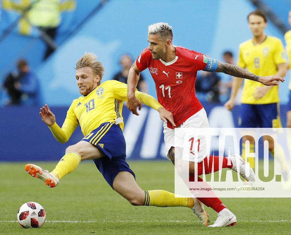 Football: Sweden vs Switzerland at World Cup Emil Forsberg (L) of Sweden and Valon Behrami of Switzerland battle for the ball during the first half of a World Cup round-of-16 match at Saint Petersburg Stadium in St. Petersburg, Russia, on July 3, 2018.