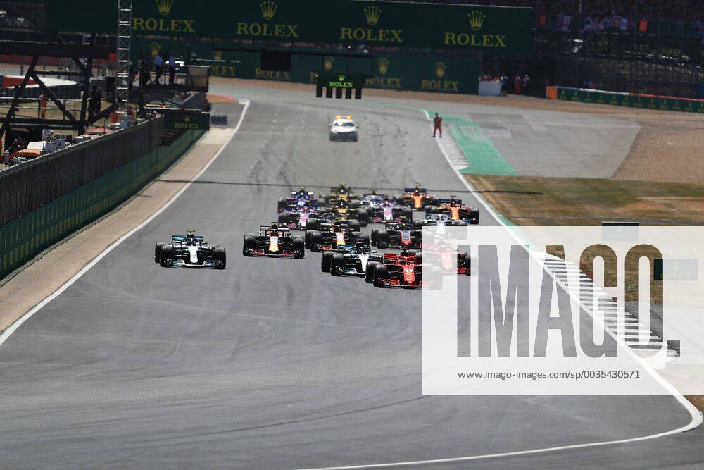 8th July 2018, Silverstone Circuit, Silverstone, England; British Formula One Grand Prix, Race Day; Scuderia Ferrari, Sebastian Vettel leads into Turn 1 ahead of Bottas after Lewis Hamilton has a poor start ActionPlus12045458 Octane