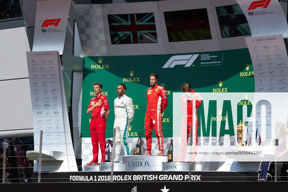 8th July 2018, Silverstone Circuit, Silverstone, England; British Formula One Grand Prix, Race Day; The podium presentation, first Scuderia Ferrari driver Sebastian Vettel, second Mercedes AMG Petronas Motorsport driver Lewis Hamilton and third Scuderia Ferrari driver Kimi Raikkonen ActionPlus12045568 TimxWilliams