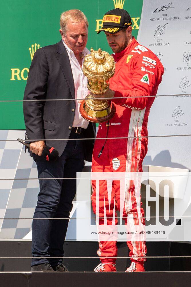 8th July 2018, Silverstone Circuit, Silverstone, England; British Formula One Grand Prix, Race Day; Scuderia Ferrari driver Sebastian Vettel looks at the winners trophy with Sky TV presenter Martin Brundle ActionPlus12045554 TimxWilliams