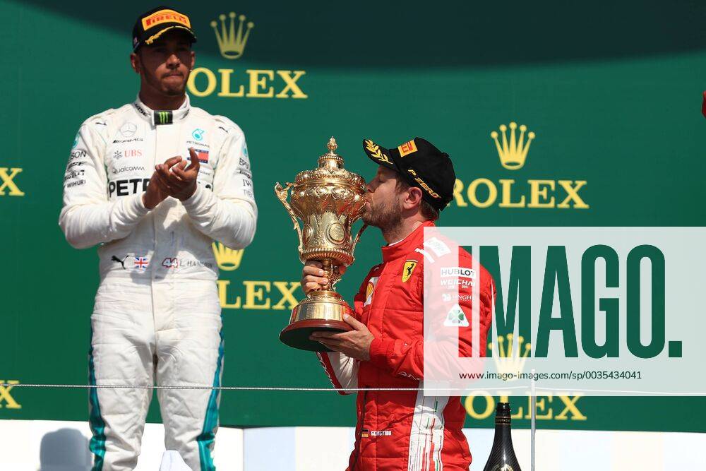 8th July 2018, Silverstone Circuit, Silverstone, England; British Formula One Grand Prix, Race Day; Scuderia Ferrari, Sebastian Vettel wins at Silverstone and kisses his trophy ActionPlus12045576 Octane
