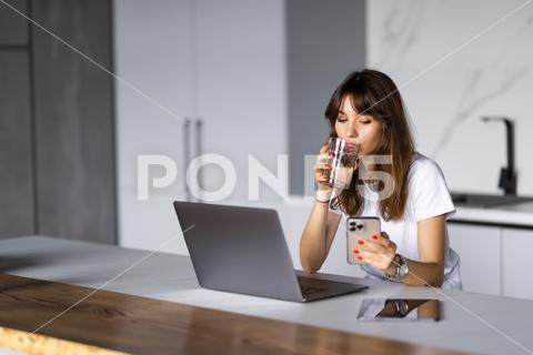 Young woman using smartphone and holding glass of water in kitchen happy, adult, glass, asian, internet, drink, smartphone, smiling, mobile, beautiful, young, phone, girl, home, kitchen, water, woman, holding, enjoying, casual, business, pretty, female, detox, using, attractive, standing, indoors, expression, cellphone