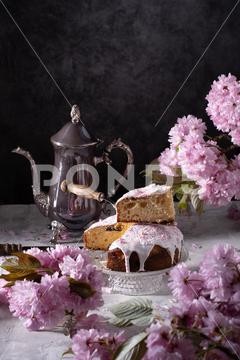 Easter cake and painted eggs and a bouquet of pink sakura flowers on a table in a decorated spring room, a beautiful still life. High quality photo provence, baking, bloom, blurry, branches, floral, flower, painted, petals, pink, preparation, season, still life, symbol, vintage, wooden, background, cake, celebration, dessert, holiday, homemade, traditional, white, bakery, closeup, easter, eggs, happy, kulich, orthodox, religion, celebrate, decoration, delicious, easter cake, food, nobody, sweet, baked, bakery products, bread, catholic copy space, christianity, easter egg, egg, family, festive