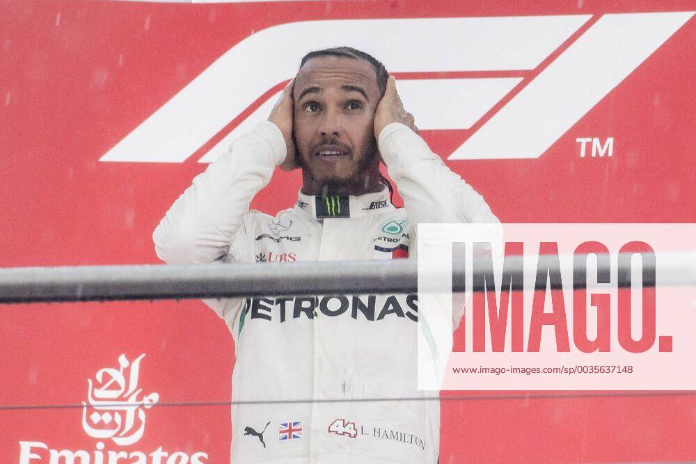 Motorsport Formula 1 Season 2018 2019 Race on Sunday 22 07 2018 at the Hockenheimring in Hockenheim Germany Lewis Hamilton Mercedes AMG Petronas beats his hands behind his head on the podium