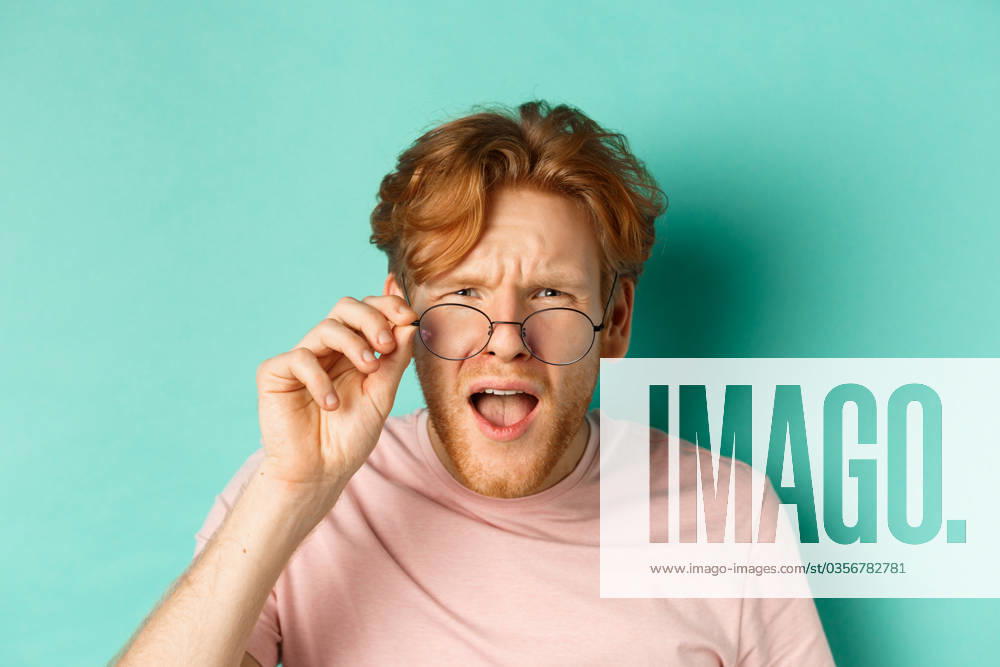 Close up portrait of redhead guy take-off glasses and looking confused at something strange, standing shocked over turquoise background., model released, , 43847028.jpg, man, male, guy, student, redhead, red, ginger, lifestyle, beard, bristle, background, fashion, person, shopping, face, attractive, handsome, adult, portrait, young, studio, one, casual, isolated, model, people, beauty, trendy, standing, modern, posing, bearded, caucasian, hair, hairstyle, indoor, confident, looking, t-shirt, advertisement, promo, spring, offer, summer, european, mint, turquoise, glasses, clueless, confused RECORD DATE NOT STATED