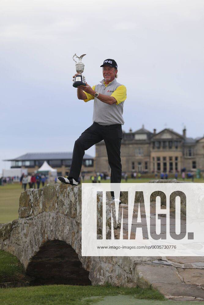 29th July 2018, Old Course at St Andrews, St Andrews, Scotland; The 2018 Senior Open Golf Championships, 4th round; This year s winner Miguel Angel Jimenez (ESP) poses with the Senior Open trophy on the Swilken Bridge on the 18th hole of the Old course ActionPlus12051763 AlanxMartin