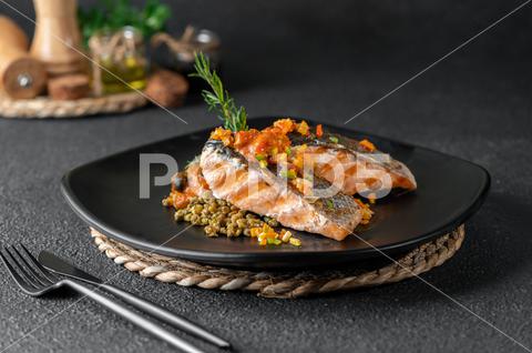 A closeup of a plate of grilled salmon with beans garnished with rosemary on the table background, beans, catering, closeup, cooked, delicious, dinner, food, fresh, garnish, gourmet, grilled, homemade, lunch, menu, recipe, restaurant, rosemary, salad, salmon, serving, snack