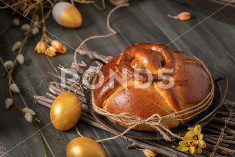 Portuguese traditional Easter cake. Folar with golden eggs on easter table. Blossom flowers and golden painted eggs. almond, anise, background, blossom, boiled, bread, cake, colorful, cook, cooked, cuisine, decoration, easter, egg, famous, fennel, flower, folar, food, gold, golden, holiday, lemon, portugal, portuguese, regional, season, seasonal, sugar, sugared, sweet, symbol, table, tasty, tea, traditional, travel, typic, typical, white, wood, wooden, yellow, zest