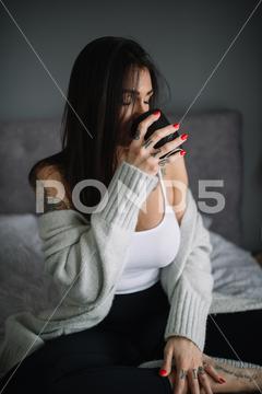 Tattoed woman drinking coffee from black cup at home, bed, bedroom, coffee, coffee break, computer, cozy, drink, enjoying, girl, hispter, lifestyle, morning, real life, relaxation, sit, surf, tattoo, trendy, woman, ždrelo, braniÄevo district, serbia, thirties, generation x, 30-35 years old, one person, female, white