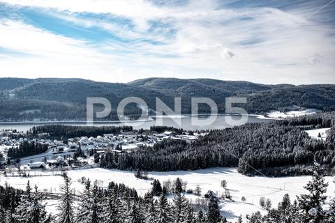 A mesmerizing view of the Black Forest in winter in Schluchsee, Germany architecture, beautiful, black, botany, branches, buildings, clouds, cold, covered, environment, europe, exterior, facade, forest, frost, germany, grass, houses, landscape, nature, outdoors, outside, schluchsee, season, sky, snow, tourism, travel, trees, winter