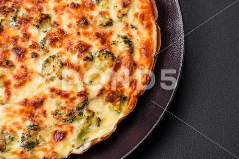 Delicious quiche with broccoli, cheese, chicken, spices and herbs on a dark concrete background broccoli, quiche, food, cheese, vegetable, meal, pie, dinner, crust, lunch, pastry, dish, egg, green, baked, cuisine, tart, snack, homemade, gourmet, french, healthy, kitchen, eating, delicious, breakfast, cooking, cake, fish, cream, table, recipe, traditional, salmon, dough, vegetarian, lorraine, background, rustic, ingredient, spinach, tasty, cooked, appetizer, gratin, wood, organic
