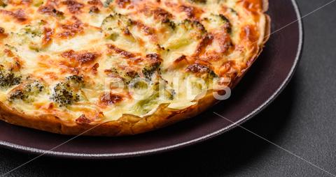 Delicious quiche with broccoli, cheese, chicken, spices and herbs on a dark concrete background broccoli, quiche, food, cheese, vegetable, meal, pie, dinner, crust, lunch, pastry, dish, egg, green, baked, cuisine, tart, snack, homemade, gourmet, french, healthy, kitchen, eating, delicious, breakfast, cooking, cake, fish, cream, table, recipe, traditional, salmon, dough, vegetarian, lorraine, background, rustic, ingredient, spinach, tasty, cooked, appetizer, gratin, wood, organic