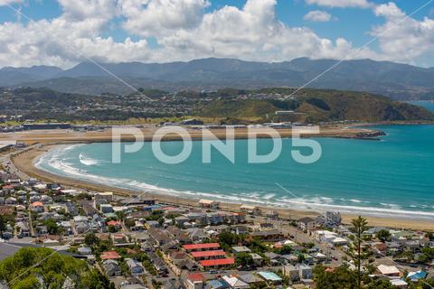 New Zealand, Wellington. Lyall Bay from an elevated position, looking east to the bay, airport and the Orongorongo Hills behind. Fine summers day. airport, bay, beautiful, blue, building, city, cityscape, coast, coastline, harbor, island, landscape, lyall, mountain, nature, new, zealand, ocean, pacific, scenic, sea, shore, sky, summer, surf, swimming, tourism, travel, vacation, view, water, wellington