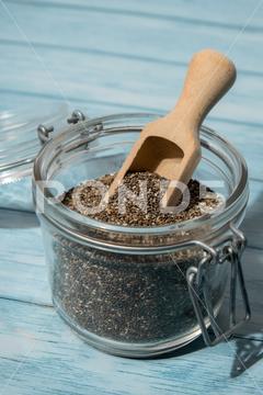 Chia seeds in glass jar. Healthy superfood rich in Omega 3 fatty acids. Dry healthy natural ingredient. Chia grains are falling. Vegetarian food organic, healthy eating, copy space, dry, glass jar, omega-3, cellulose, chia, ketogenic, supplement, cholesterol, food, raw, supplements, raw food, bowl, seed, agriculture, backgrounds, protein, diet, healthy, nutrition, dieting, amino acid, vegetarian food, macro, ingredient, closeup, chia grains, close-up, chia seed, heap, cereal plant, earthy, breakfast, chia seeds, jar, health, vegetarian, health benefits, superfood, background, natural, nutritious, grain free, ingredients, nutritional supplement, antioxidant