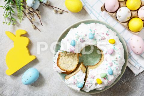 Glazed easter lemon cake decorated with confectionery and mini chocolate eggs candy on gray stone background. Happy Easter holidays, tasty dessert. View from above. easter dessert, colorful eggs, biscuit, kulich, happy easter, decor, cake, holiday, celebration, decoration, season, pastry, dessert, bakery, sweet, spring, homemade, table, food, meal, eating, glazed, icing, springtime, background, confectionery, chocolate, card, trendy, panettone, breakfast, meringue, celebrate dessert, lemon, frosting, decorated, frosted, brunch, bunny, rabbit, bakers, christian, cookie, easter eggs, easter rabbit, event, menu, easter bunny, seasonal