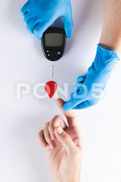 Hands of gloved doctor with glucometer taking blood sugar reading from caucasian woman. Blood sugar, diabetes and health awareness. Two People, Mid Adult, Man, Male, White, Mature Adult, Woman, Female, People, Hand, Gloved, Doctor, Glucometer, Taking, Blood, Sugar, Reading, Caucasian Woman, Diabetes, Health, Awareness, Medical, Medicine, Hospital, Clinic, Healthcare, Care, Patient, Diabetic, Treatment, Disease, Glucose, Illness, Healthy, Insulin, Nurse, Hypoglycaemia, Professional, Laboratory, Test, Person, Caucasian