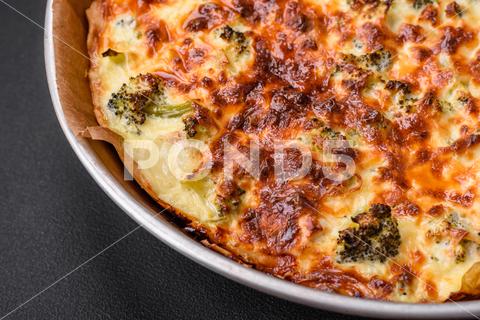 Delicious quiche with broccoli, cheese, chicken, spices and herbs on a dark concrete background broccoli, quiche, food, cheese, vegetable, meal, pie, dinner, crust, lunch, pastry, dish, egg, green, baked, cuisine, tart, snack, homemade, gourmet, french, healthy, kitchen, eating, delicious, breakfast, cooking, cake, fish, cream, table, recipe, traditional, salmon, dough, vegetarian, lorraine, background, rustic, ingredient, spinach, tasty, cooked, appetizer, gratin, wood, organic