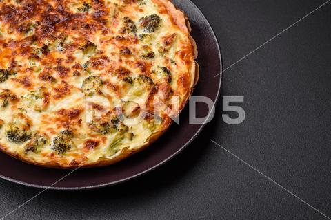 Delicious quiche with broccoli, cheese, chicken, spices and herbs on a dark concrete background broccoli, quiche, food, cheese, vegetable, meal, pie, dinner, crust, lunch, pastry, dish, egg, green, baked, cuisine, tart, snack, homemade, gourmet, french, healthy, kitchen, eating, delicious, breakfast, cooking, cake, fish, cream, table, recipe, traditional, salmon, dough, vegetarian, lorraine, background, rustic, ingredient, spinach, tasty, cooked, appetizer, gratin, wood, organic