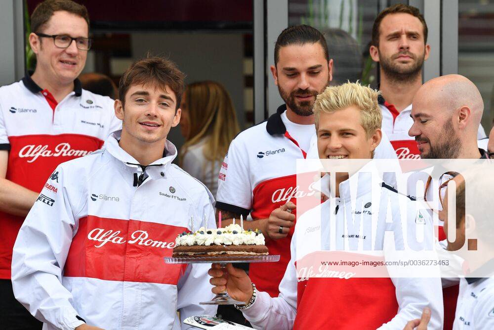 Left Charles Leclerc Alfa Romeo Sauber F1 Team passes birthday cake to Marcus Ericsson Alfa Romeo Sauber F1 Team Italian Grand Prix Renntag 02 09 2018 ITA Italian Grand Prix 02 09 2018 Monza