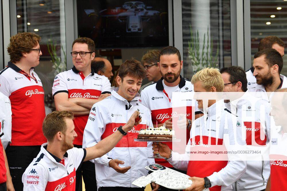 Left Charles Leclerc Alfa Romeo Sauber F1 Team passes birthday cake to Marcus Ericsson Alfa Romeo Sauber F1 Team Italian Grand Prix Renntag 02 09 2018 ITA Italian Grand Prix 02 09 2018 Monza