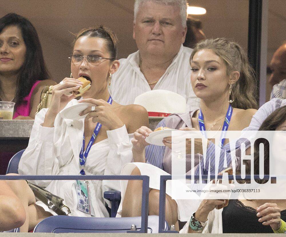 Flushing Meadows, New York, U.S - Bella and Gigi Hadid enjoy a hot dog during the Serena Williams quarter-final victory on day 9 of the 2018 tennis US Open on Arthur Ashe stadium at the USTA Billie Jean King National Tennis Center on September 4, 2018 in Flushing Meadows, Queens, New York City. Bella and Gigi Hadid at US Open Day 9 - ZUMAp124 20180904_zaa_p124_100