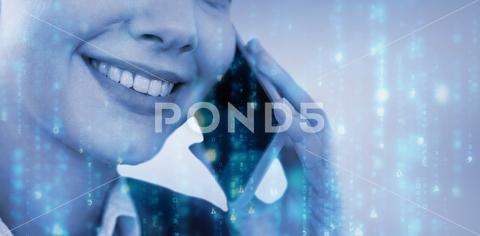 Close up of smiling businesswoman talking on mobile phone against digitally generated black and blue matrix 20s, Young Adult, Woman, Female, Caucasian, 3d, Digital Generated, Computer Graphic, Colour, Vignette, Grey, Wallpaper, Studio Shot, Businesswoman, Business, Career, Professional, Profession, Occupation, Job, Corporate, Expertise, Holding, Smiling, Cheerful, Happy, Calling, On The Phone, Phoning, Phone Call, Talking, Conversation, Interacting, Speaking, Smartphone, Mobile Phone, Cellphone, Phone, Wireless Technology, Communication, Connection, Beautiful, Pretty, Mid Section, Technology, Matrix, Light, Data, Computer, Computing, Blue, Black, Copy Space, Close-up