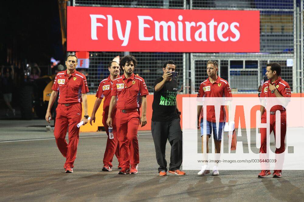 13th September 2018, Marina Bay Street Circuit, Singapore; Formula One Grand Prix of Singapore, driver arrivals and press conference PK Pressekonferenz Fan asks Scuderia Ferrari, Sebastian Vettel for a photo as he walks the track ActionPlus12061889 Octane