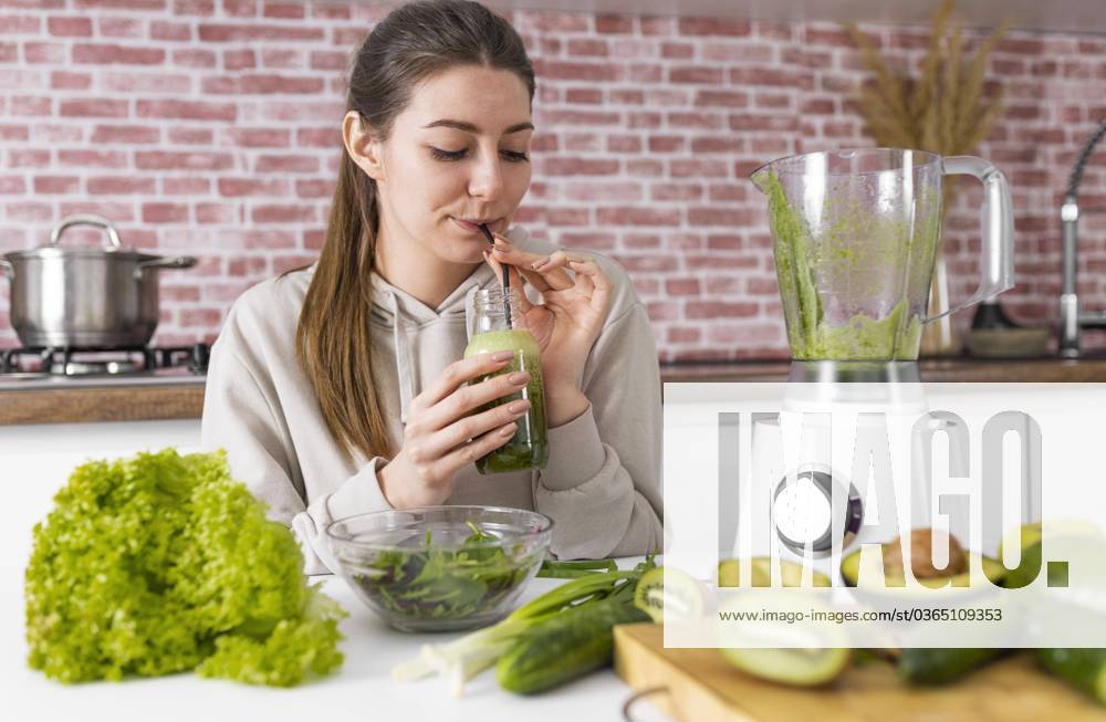 Medium Shot Woman drinks Greens Smoothie