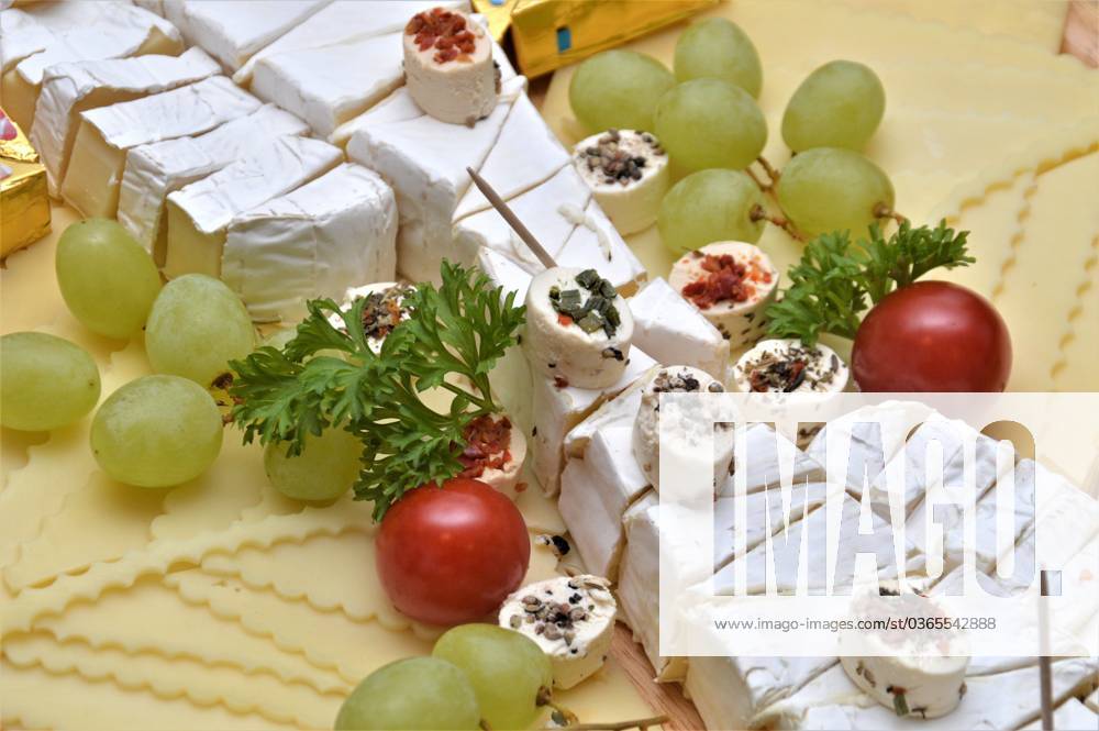 Cheese platter Germany Saxony Anhalt Altmark Kusey cheese platter various cheeses such as semi-hard cheese Camenbert cream cheese decorated with grapes tomatoes parsley