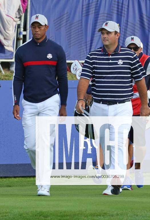 Tiger Woods (L) and Patrick Reed walk towards the fairway after hitting their opening shots on the first tee at the start of the Ryder Cup at Le Golf National in Guyancourt near Paris on September 28, 2018. Team USA will compete against Team Europe in the three-day tournament. PAR20180928088 DAVIDxSILPA
