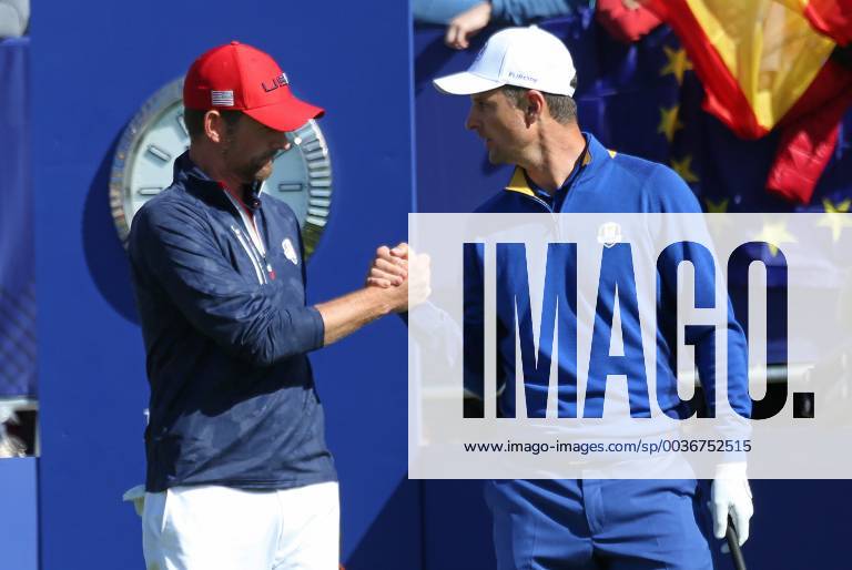 Webb Simpson (L) shakes hands with Justin Rose before the start of the final day of competition of the Ryder Cup at Le Golf National in Guyancourt near Paris on September 30, 2018. Team Europe leads Team USA 10-6 heading into the final day of competition. PAR20180930017 DAVIDxSILPA