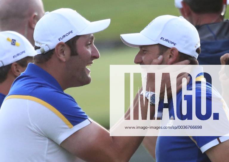 Jon Rahm (L) and Sergio Garcia celebrate after Team Europe clinches the Ryder Cup at Le Golf National in Guyancourt near Paris on September 30, 2018. Team Europe defeated Team USA 17.5 to 10.5 to hand the Americans their sixth straight loss on foreign soil. PAR20180930067 DAVIDxSILPA