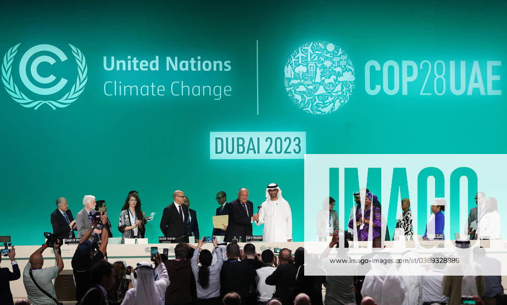 (231130) -- DUBAI, Nov. 30, 2023 -- COP28 President Sultan Ahmed Al Jaber (5th R, front) receives a gavel from COP27 President Sameh Shoukry (4th L, front) during the opening ceremony of the 28th session of the Conference of the Parties to the United Nations Framework Convention on Climate Change, or COP28, in Dubai, the United Arab Emirates, Nov. 30, 2023. This year s climate conference has garnered notable global attention as it marks the conclusion of the Global Stocktake, the first-ever two-year assessment of the world s collective progress toward the goals of the 2015 Paris Agreement. The conference, running from Nov. 30 to Dec. 12, will welcome more than 70,000 delegates from around the globe in a bid to work out a worldwide solut