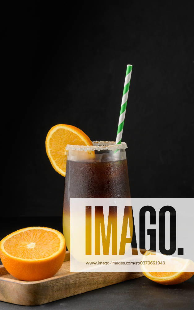Iced coffee with orange juice in a transparent glass, refreshing bumble coffee on the table Iced coffee with orange juice in a transparent glass, refreshing bumble coffee on the table