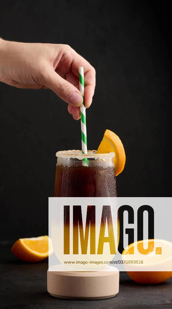 Iced coffee with orange juice in a transparent glass, refreshing bumble coffee on the table Iced coffee with orange juice in a transparent glass, refreshing bumble coffee on the table