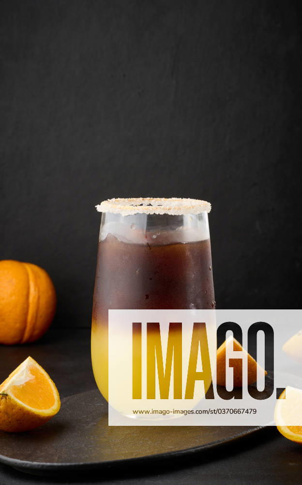 Iced coffee with orange juice in a transparent glass, refreshing bumble coffee on the table Iced coffee with orange juice in a transparent glass, refreshing bumble coffee on the table