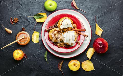 Baked apples stuffed with granola and nuts.Baked apples with nuts apple baked stuffed nut dessert autumn oatmeal filled food ice cream fruit baked apple sweet cinnamon plate delicious fall caramel syrup sugar walnut tasty ice cream bake caramel season dish syrup sauce eat prepared cinnamon stick table scoop fallen leaves seasonal tempting granola appetizing stuffed apples flat lay