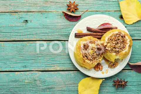 Baked apples stuffed with granola and nuts.Baked apples with nuts.Space for text apple baked stuffed fruit dessert stuffed apple sweetness stuffed apples nut dessert autumn oatmeal filled food fruit baked apple sweet cinnamon plate delicious fall homemade sugar walnut tasty bake caramel season dish syrup sauce eat prepared cinnamon stick scoop fallen leaves seasonal tempting granola appetizing copy space space for text wooden background wooden table