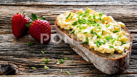 Bread with eggs salad and chives and two strawberry on rustic old wooden table with copy space background copy space cuisine culinary delicious diet dinner eating egg egg spread food fresh fruit gourmet homemade hungry ingredient lunch meal nutrition ready to eat red rustic snack strawberry sweet tasty text space textured vegetarian wood